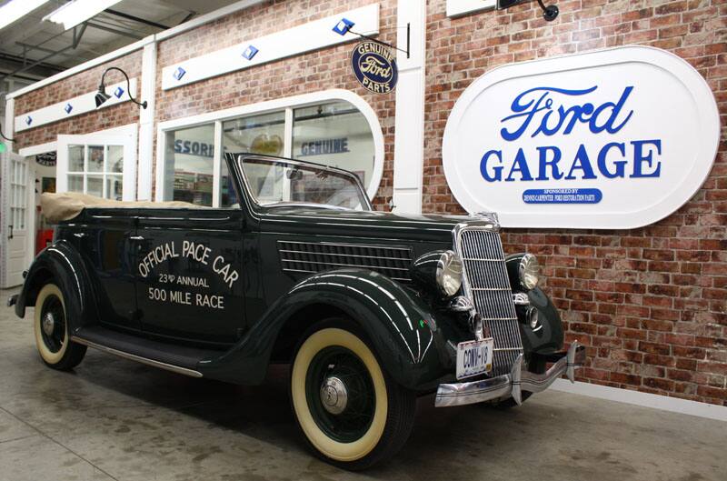 ford v8 truck in front of ford garage sign