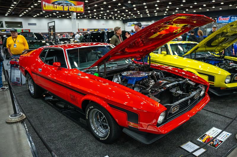 Red and Yellow Mustangs with hoods up