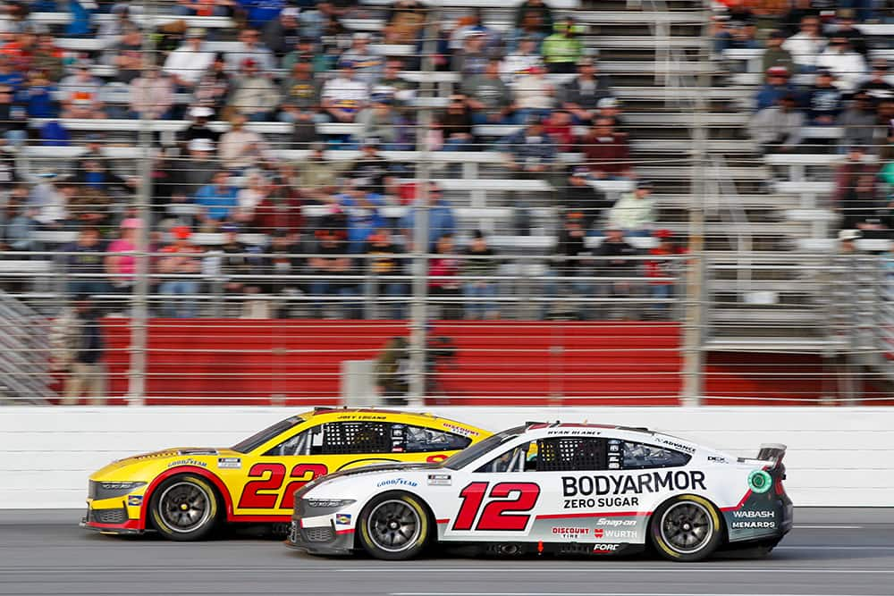 Number 22 and Number 12 Stock Cars racing on a track