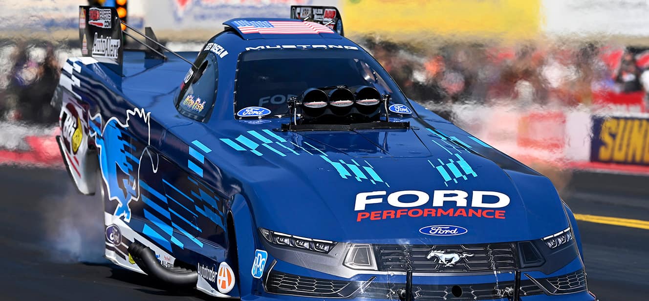 Bob Tasca's Blue Number 3 Ford Mustang Dark Horse Funny Car race car on paved track