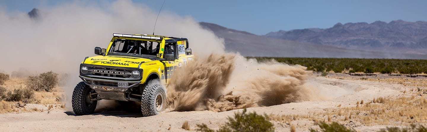 Bailey Cole’s yellow number 4613 Ford Bronco 4600 race truck off track