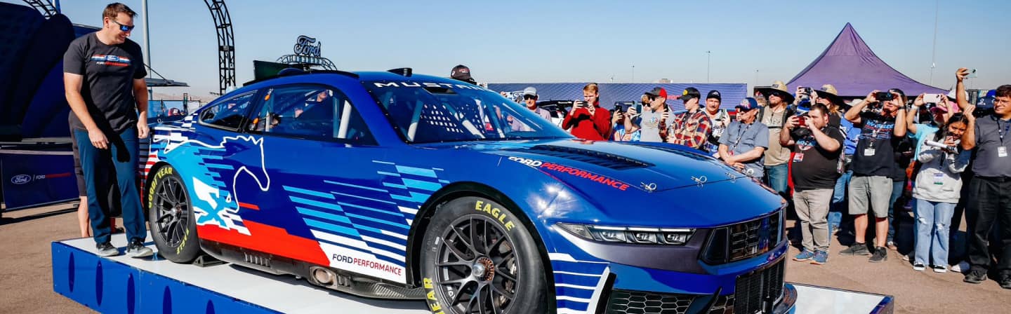 Spectators cheer on driver and race car