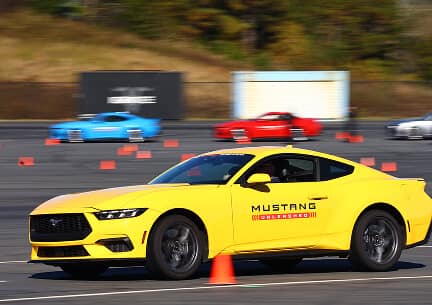 Yellow Mustang navigating around pylons