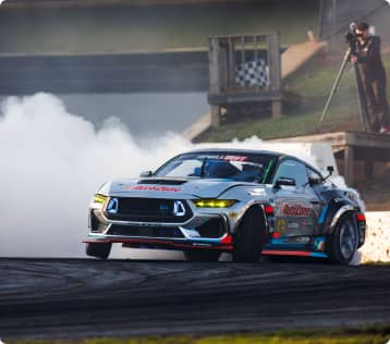 Race car in motion with smoke emerging from rear