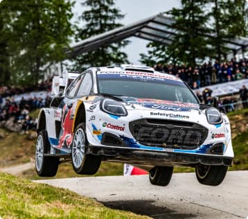 Race car with spectators in the background