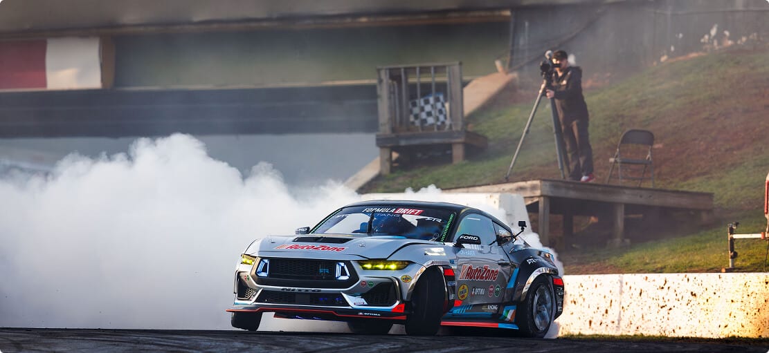 Race car in motion with smoke emerging from rear