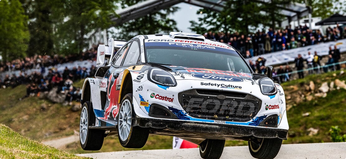 Race car with spectators in the background