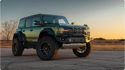 Bronco Raptor stationary against backdrop of sunset	