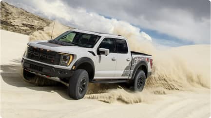 F-150 Raptor R in motion against a backdrop of sandy dunes