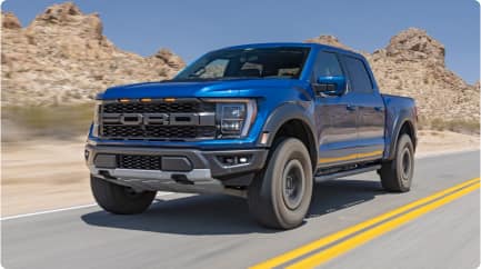 F-150 Raptor in motion against backdrop of mountains