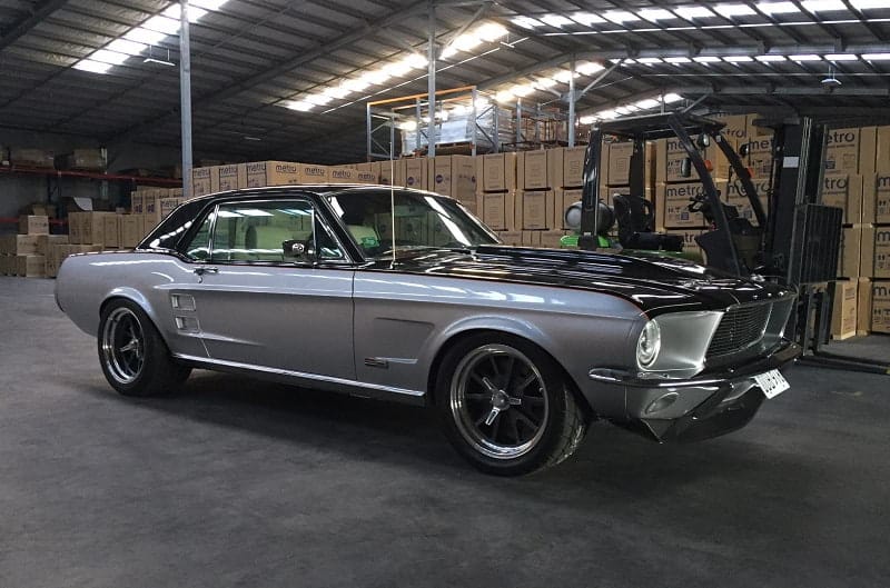 Passenger side view of 1967 Mustang Coupe parked in warehouse