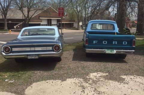 Rear view of 1966 F-100 pickup truck parked next to 1964 Ford Galaxie 500