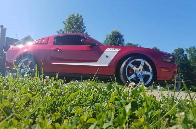 Passenger side view of 2015 Ruby Red 50th Anniversary Edition Mustang GT