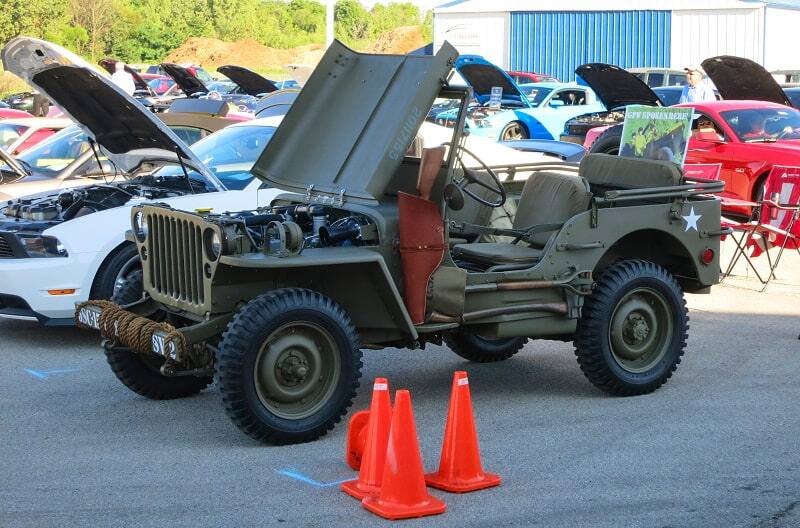 Side view of 1942 Ford GPW Jeep parked with hood propped open at 39th Annual Mustang Show