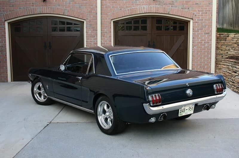 Rear profile of 1966 Mustang Coupe parked in front of garage