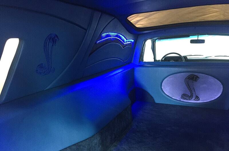 View of redone interior inside of 1978 Ford Courier pickup truck with neon blue lighting