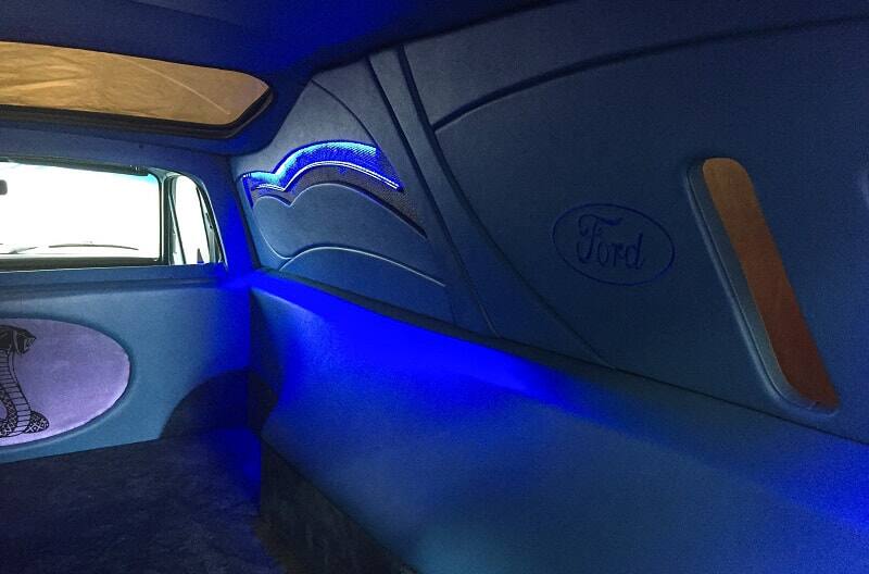 View of redone interior inside of 1978 Ford Courier pickup truck with neon blue lighting