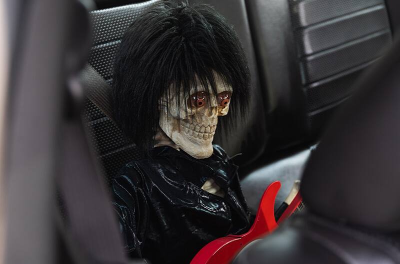 Photo of Rockstar doll with red guitar sitting in the back seat