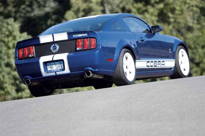 Side view of Honorary 2005 Mustang Cobra with trees in background