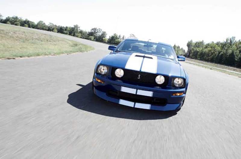 Front view of Honorary 2005 Mustang Cobra in motion at racetrack