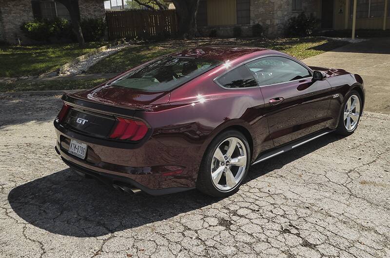 Rear view of Royal Crimson 2018 Mustang GT Premium parked on pavement