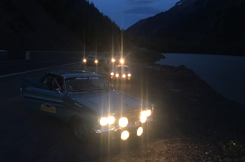 Cars during the Alcan 5000 with lights on at night