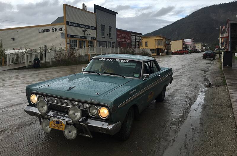 Front view of 1964 Mercury Comet Caliente parked on street on a rainy day