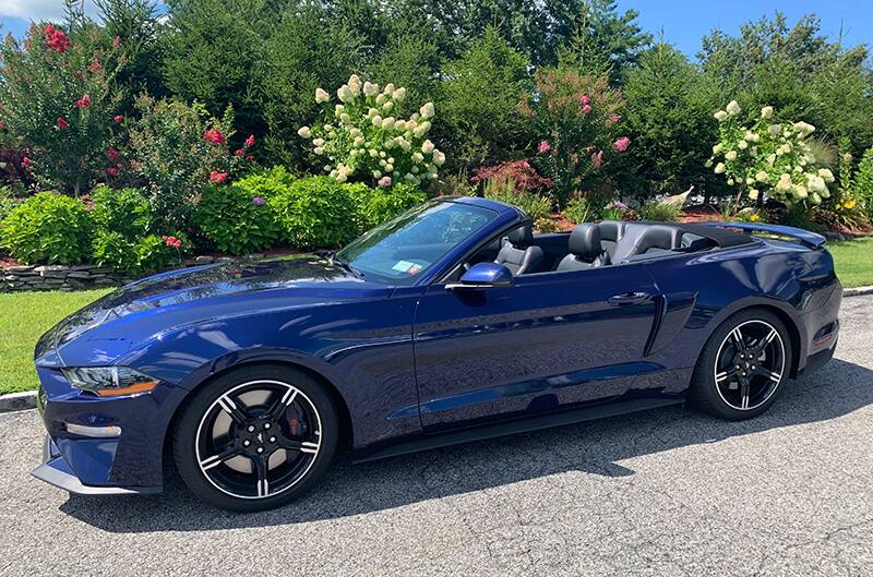 Driver side view of Kona Blue 2019 Mustang GT California Special Convertible parked on street