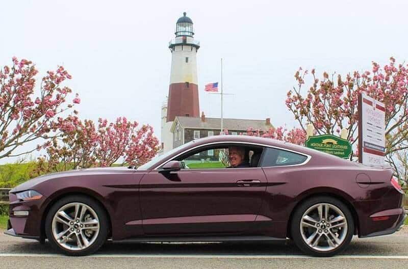 Dennis Healy smiling at the camera from the inside of his 2018 Royal Crimson Premium EcoBoost Coupe