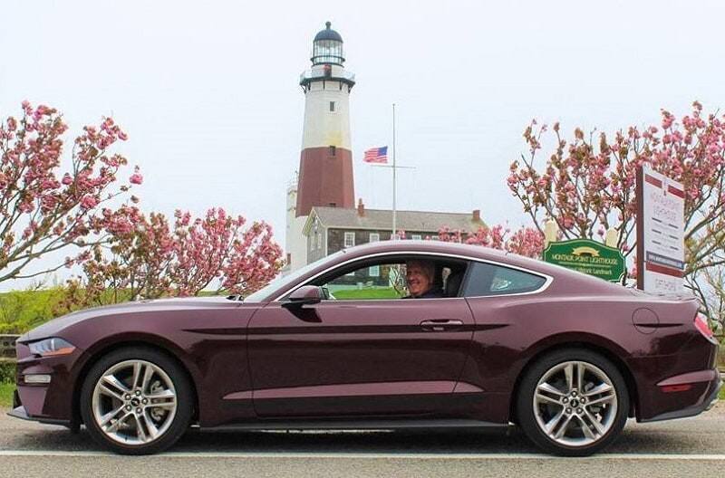 Dennis Healy smiling at the camera from the inside of his 2018 Royal Crimson Premium EcoBoost Coupe