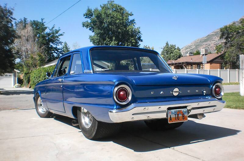 A rear side view of a blue Falcon on display