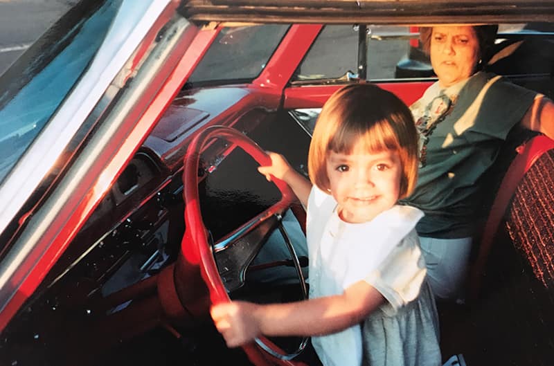 Young child in front seat of white Ford Starliner