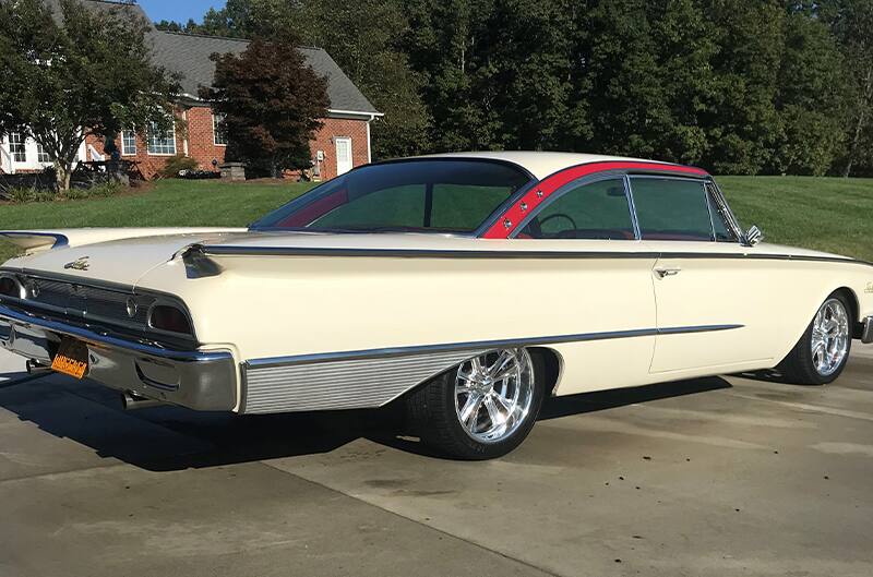 Rear profile of the white Ford Starliner in the driveway