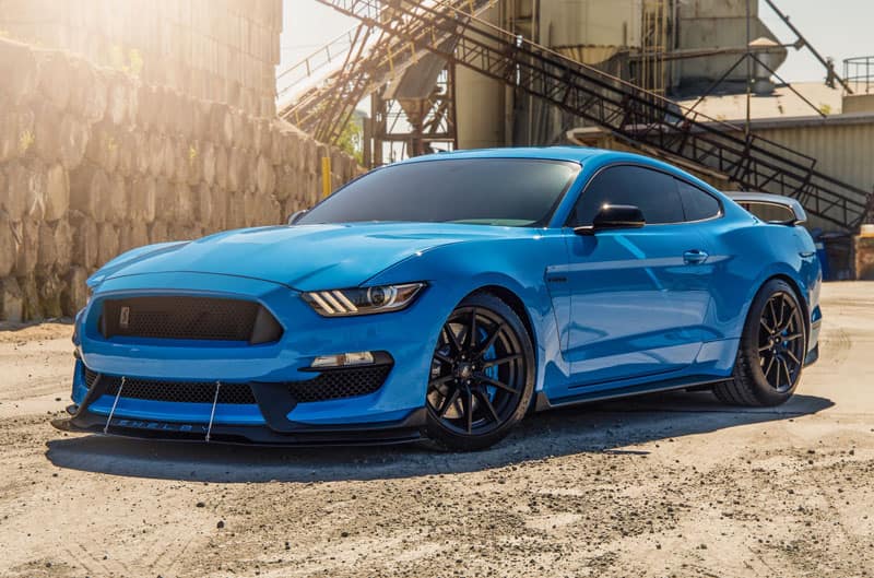 A front side view of a blue Shelby Mustang