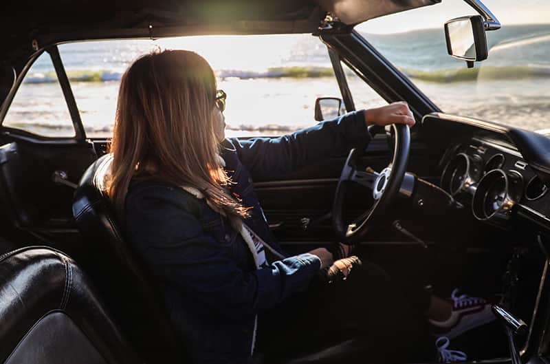 Interior shot of Gelica in front seat of her Mustang