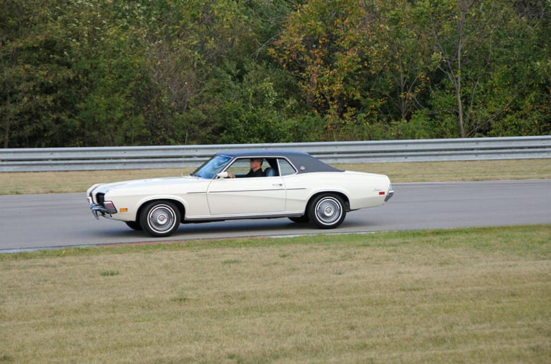 White Cougar driving on track