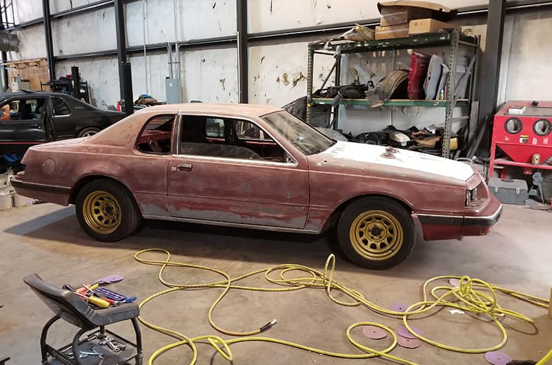 1986 Ford Thunderbird in body shop for paint