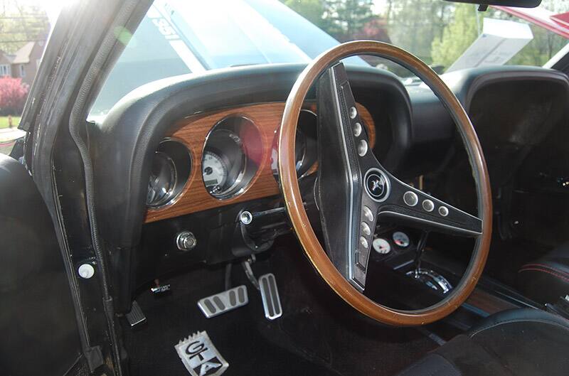 Interior photo of 1969 Mustang with wooden steering wheel