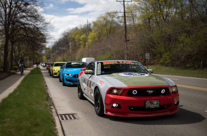 Redtail pulling into car show along street