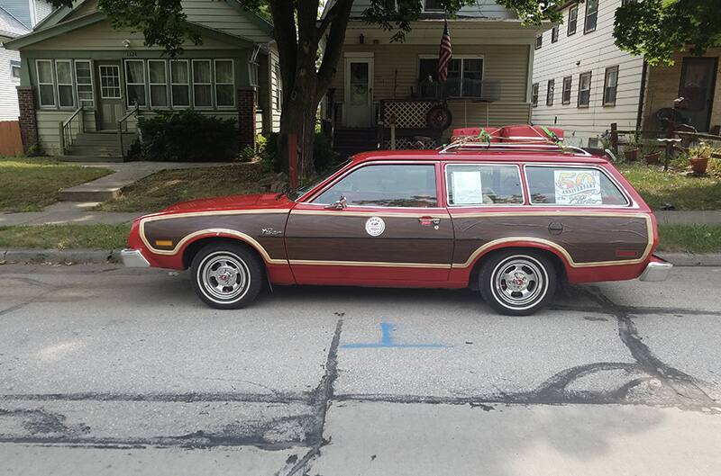 Pinto parked in front of house next to curb