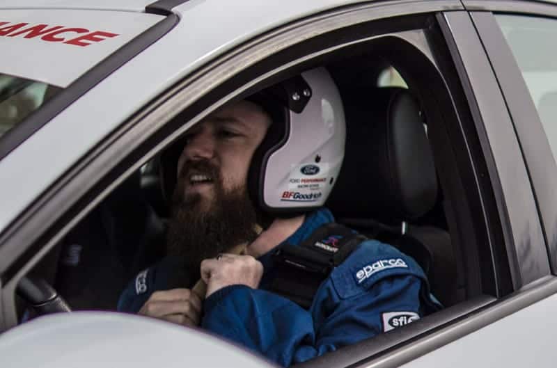 Close up of a student in the front seat with helmet on