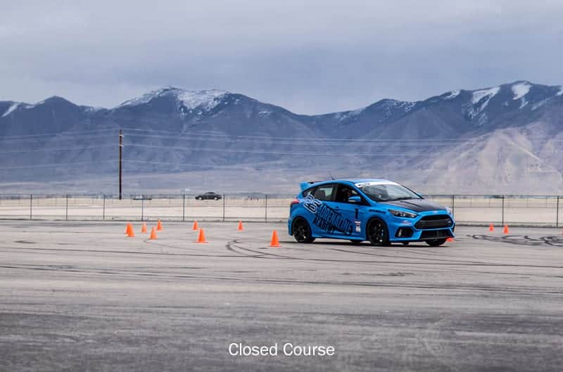 Profile of blue Focus driving the course parking lot