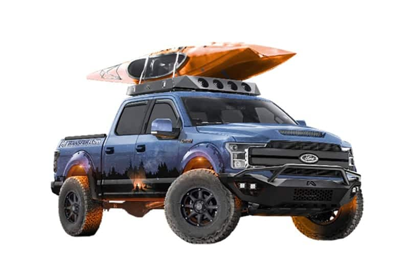 Front profile of a blue and black F150 with a canoe on the roof