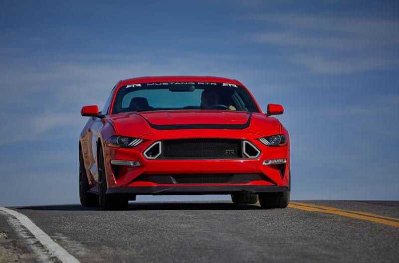 Front of a red Mustang RTR on the road