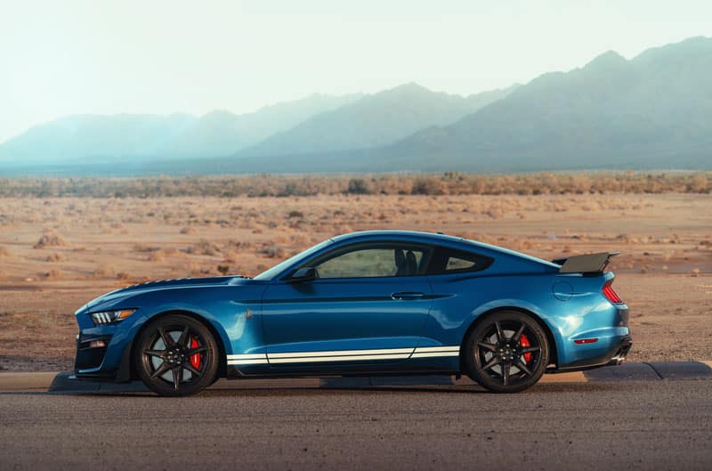 A side view of a blue Mustang