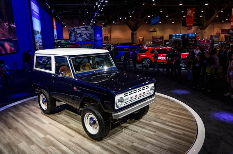A front side view of a classic blue Bronco