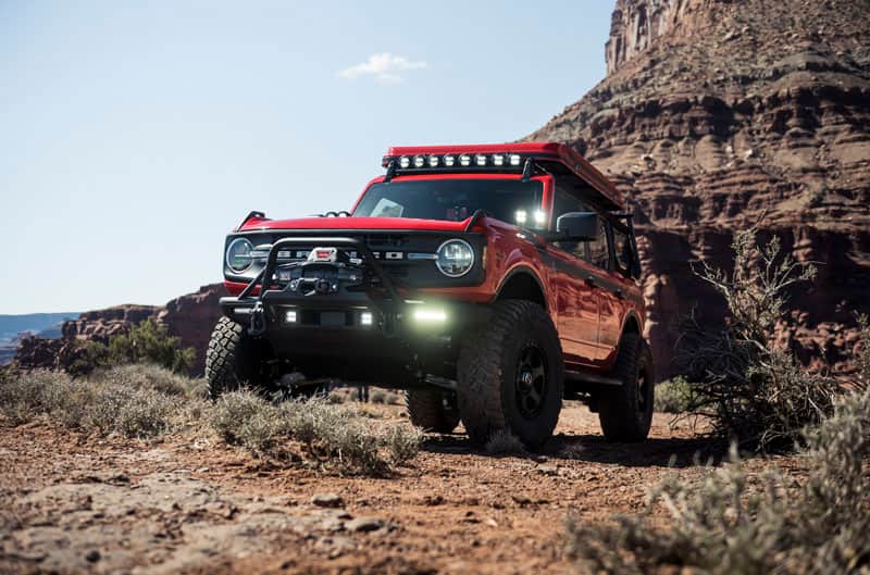 Red Bronco on dirt and rock