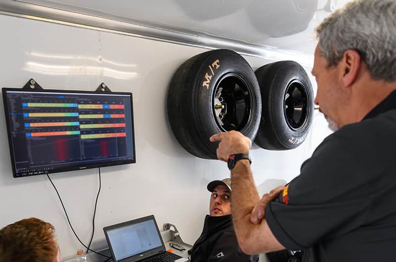 Engineers inside a trailer reviewing data