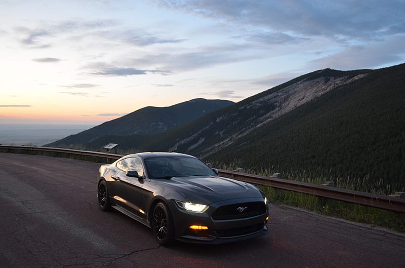S550 Mustang at dusk with mountains in rear