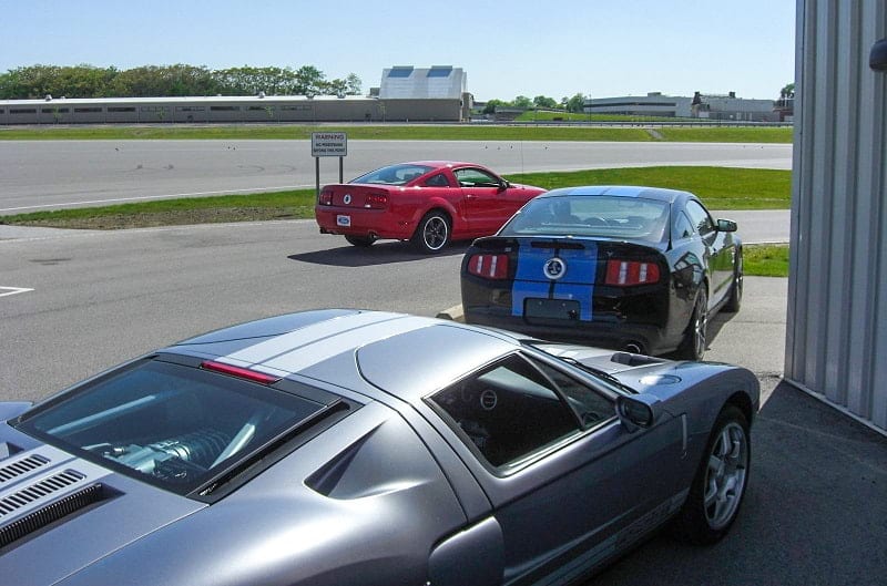 The red Bullitt and two Shelby GT500s are pictured on the track at the Ford Dearborn Development Center